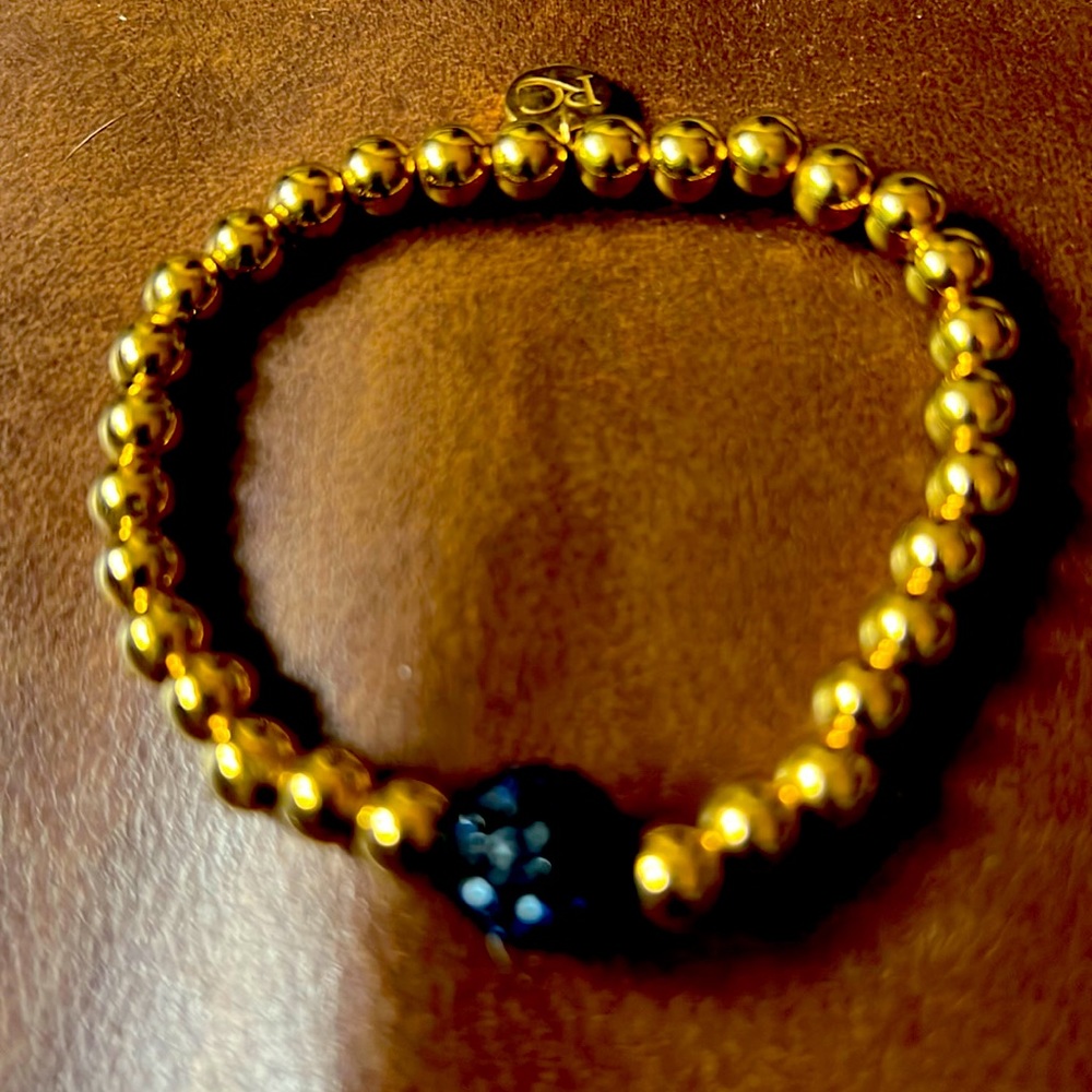 Rustic Cuff Ireland. Navy bead with gold beads and RC logo tag